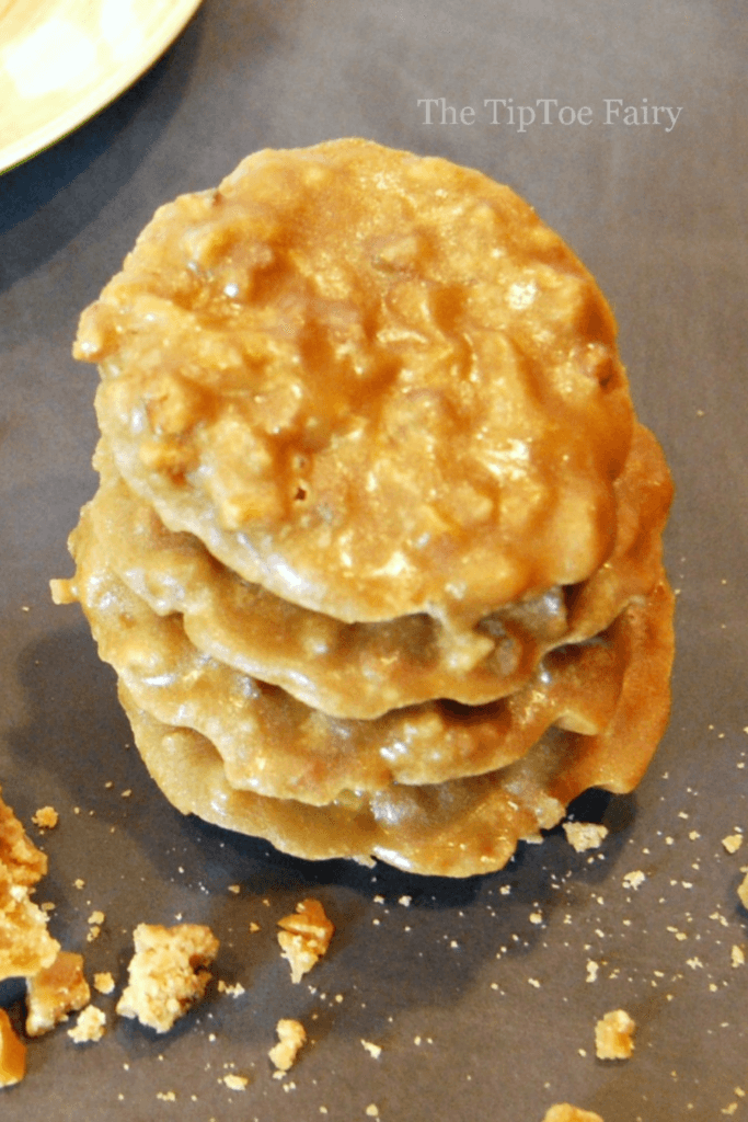 Close up view of a stack of four pecan pralines. 