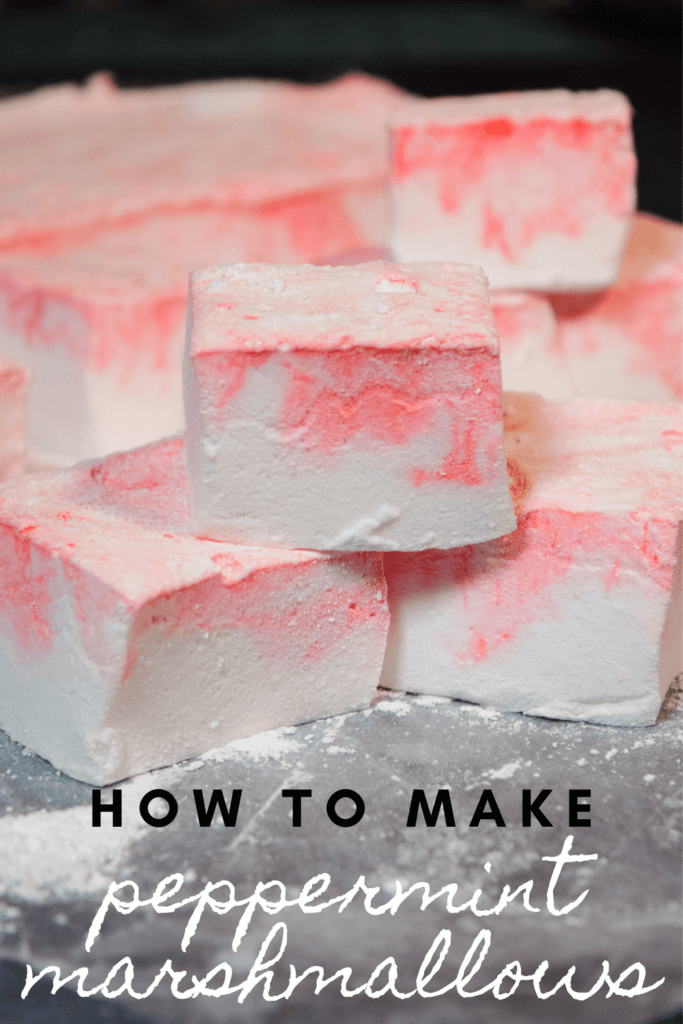 Title image for Homemade Peppermint Marshmallows swirled red and white and stacked on top of each other on wax paper. 