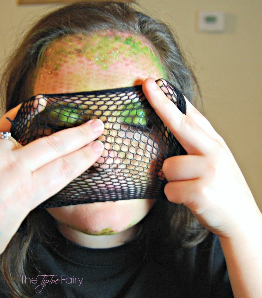 Cut open the fishnet to apply make up to face. 