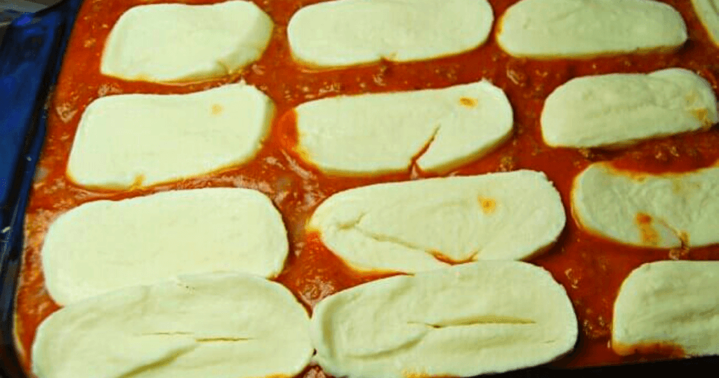 Adding the finishing touches of fresh mozzarella slices before baking. 