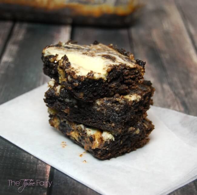 Triple Threat Brownies - filled with chocolate, peanut butter cups, and cheesecake. The perfect dessert! | The TipToe Fairy