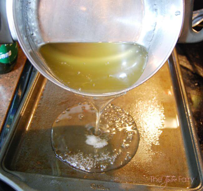 Pouring out the sugar glass to the cookie sheet.