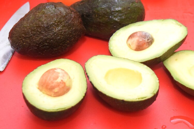 4 avocados with 2 sliced in half