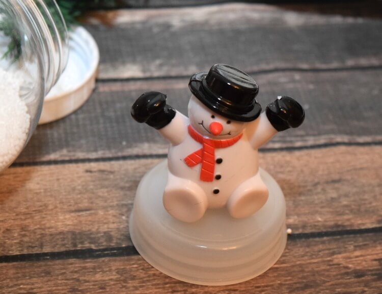 A snowman toy from my Christmas Snow Globe Wreath from @DollarTree & it lights up! #ad #DollarTree