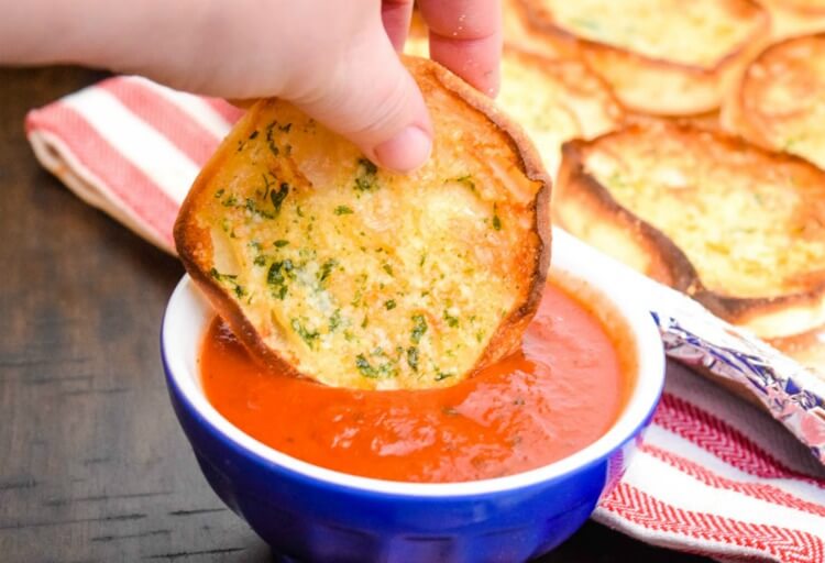 Dipping English Muffin Garlic Bread in spaghetti sauce