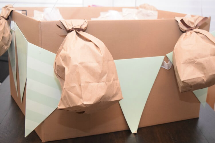 Attach lunch bag sandbags to box. 