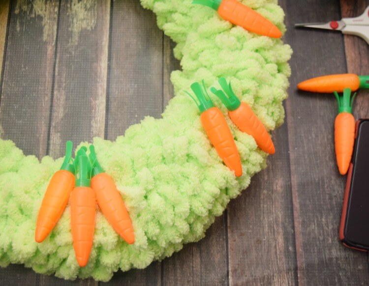 Lay out your carrots on the wreath before hot gluing them in place. 