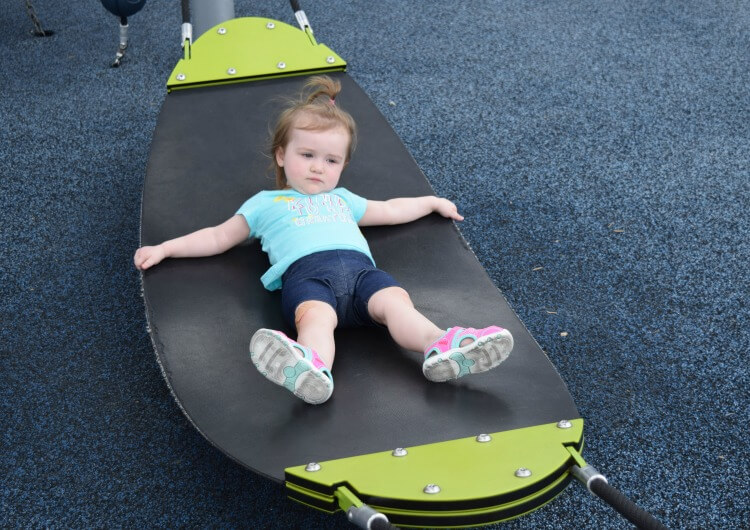 Swinging on the hammock at the playground.