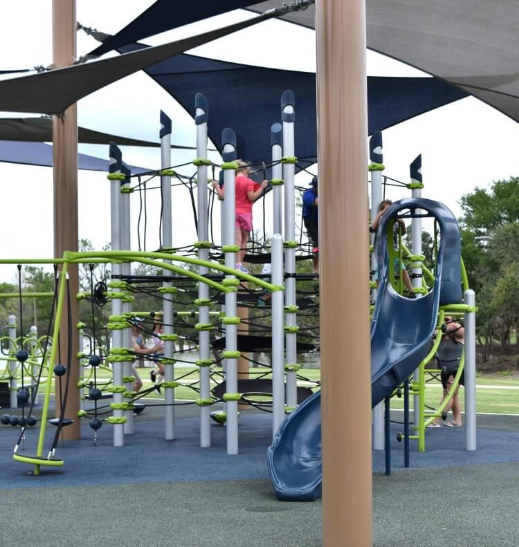 Climbing up a huge jungle gym rope structure.