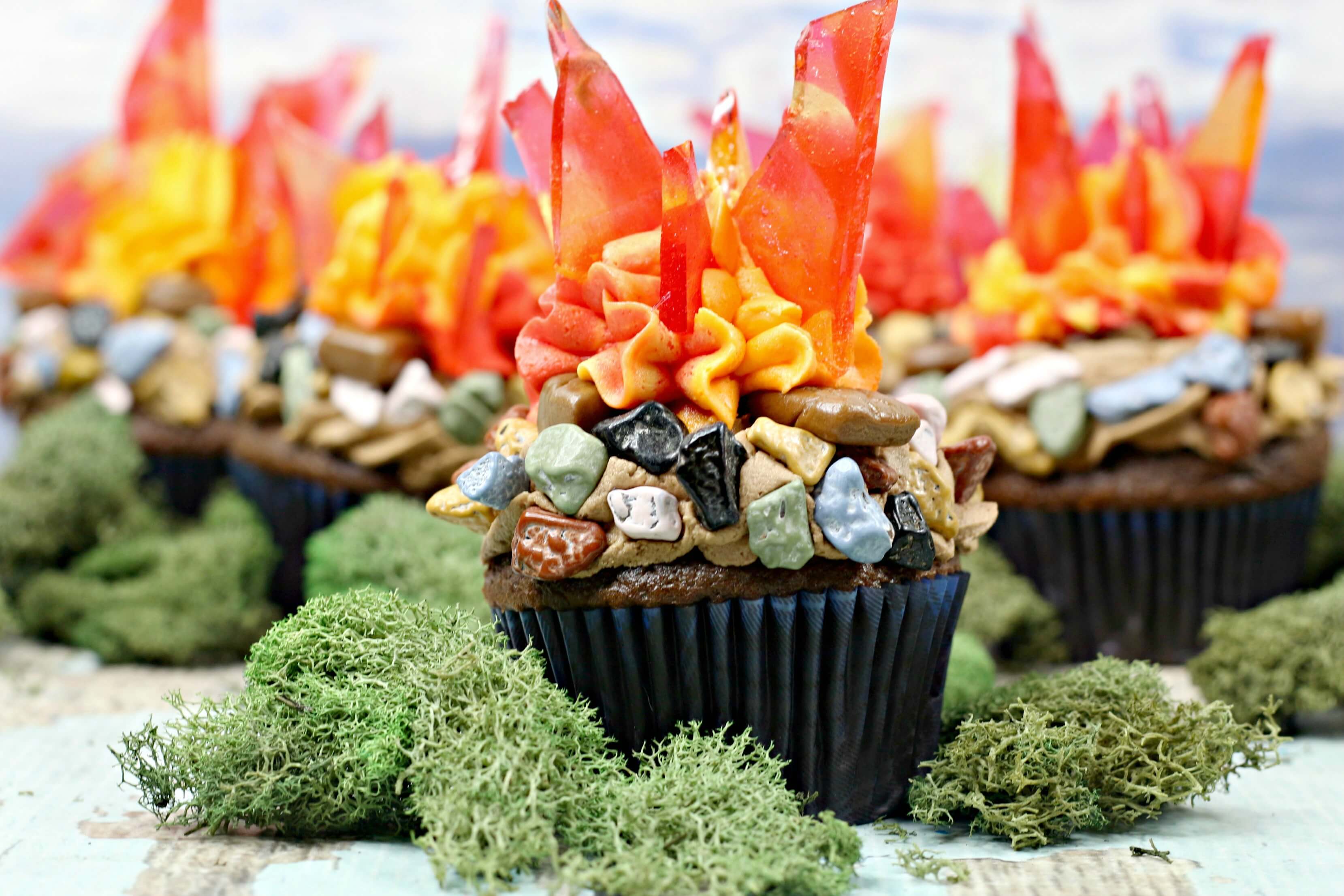 Multiple Campfire Cupcakes surrounded by moss. 