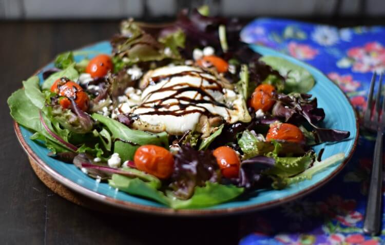 Low Carb Sheet Pan Caprese Chicken Thighs over salad greens