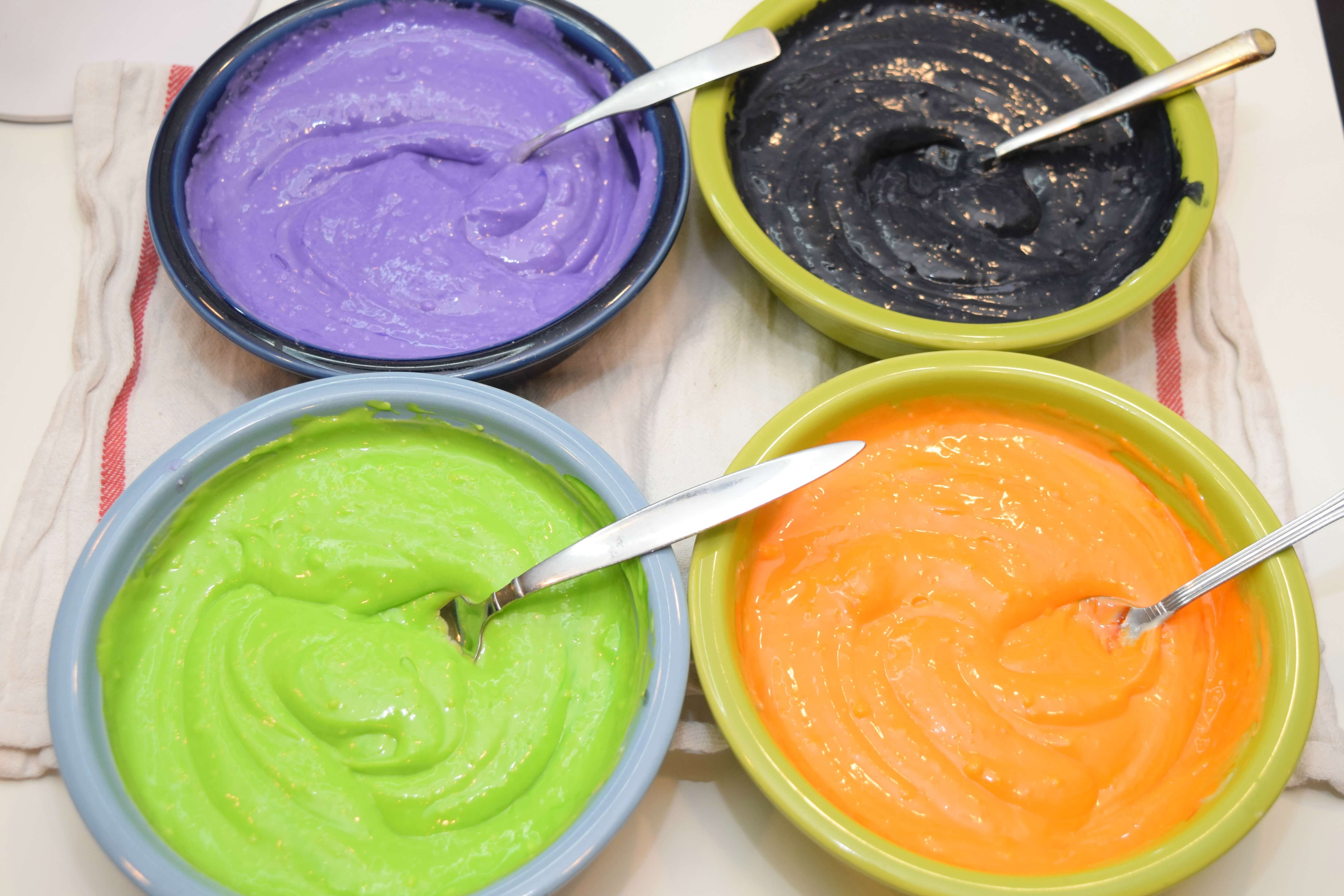 Divide the cheesecake batter into four Halloween colors.