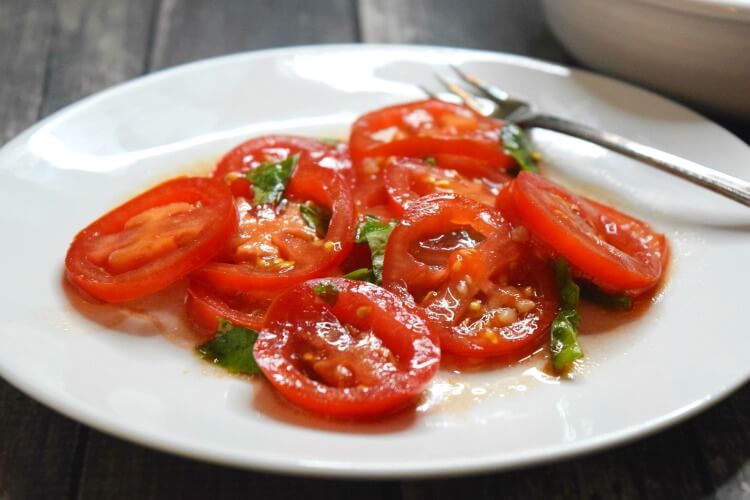 A close up of this delicious and simple tomato and basil salad.