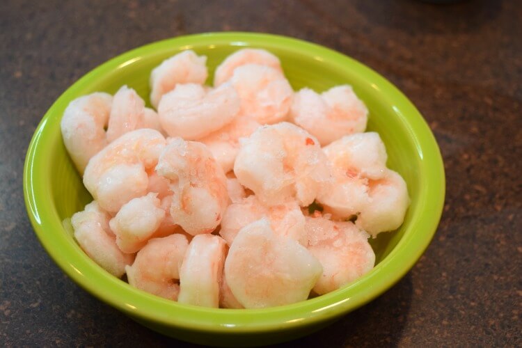 Frozen precooked shrimp with tails removed. 