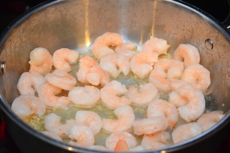 Sauteing the shrimp in Mazola Corn Oil and garlic.