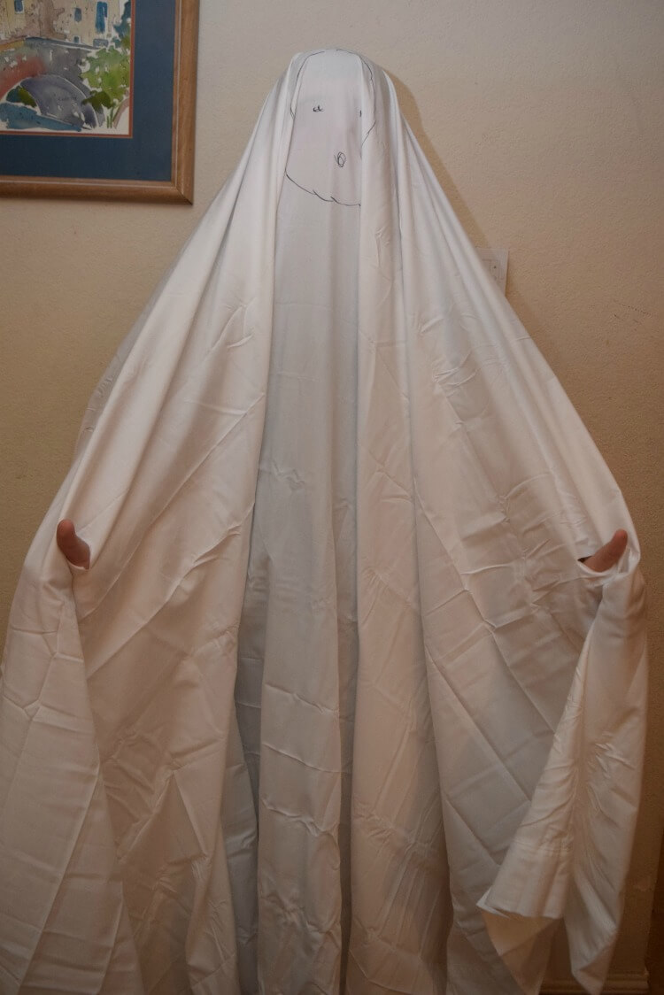 Turning a sheet into a ghost costume