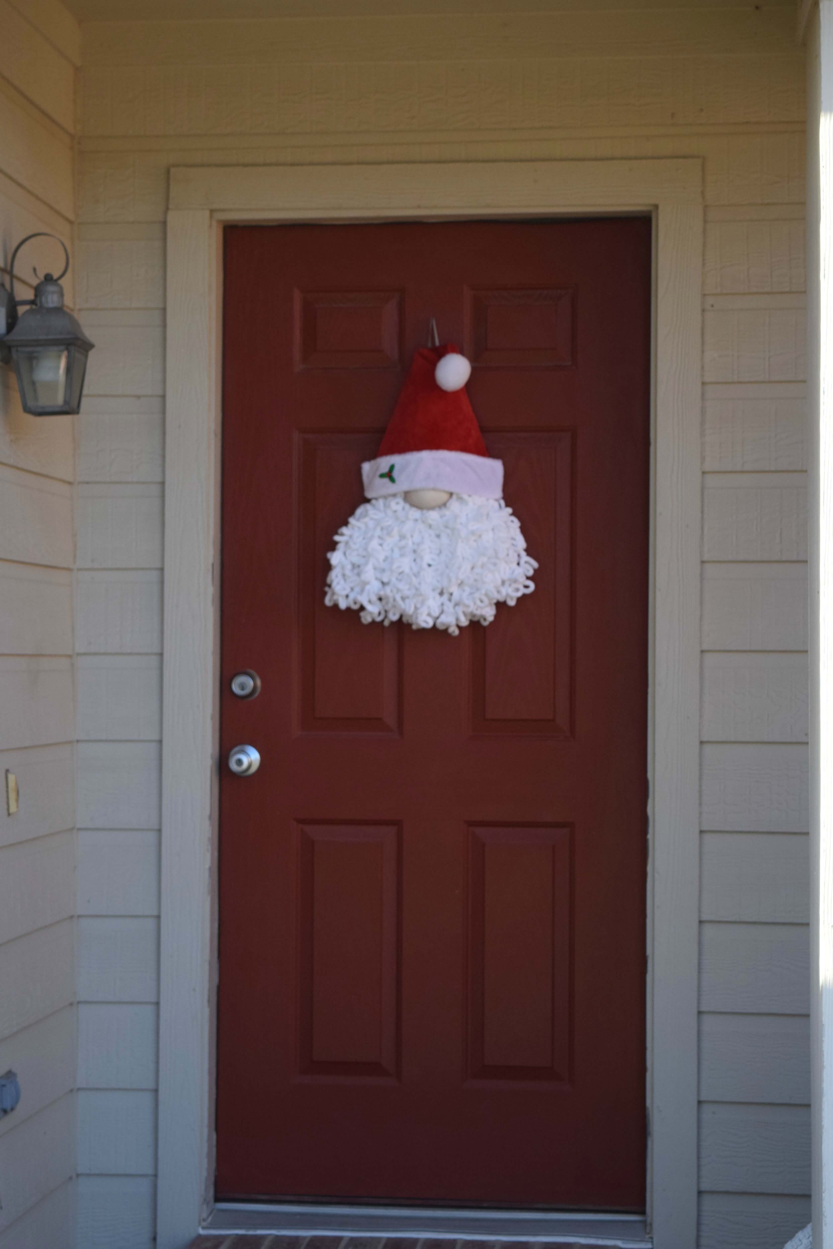 DIY Loop Yarn Christmas Santa Wreath on the front porch.