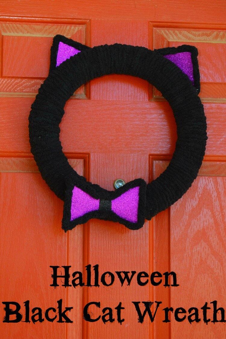 Black Cat Wreath with purple ears and bow tie on the front door. 