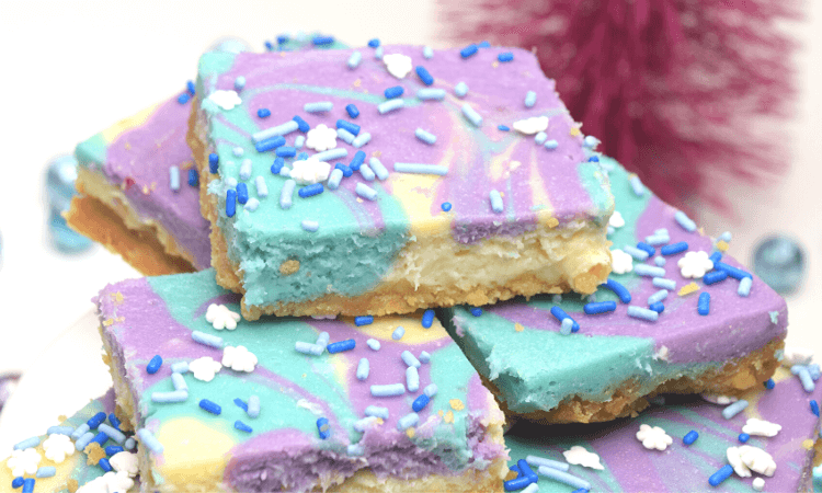 Frozen inspired Cheesecake Bars with swirls of light blue and light fuchsia. 