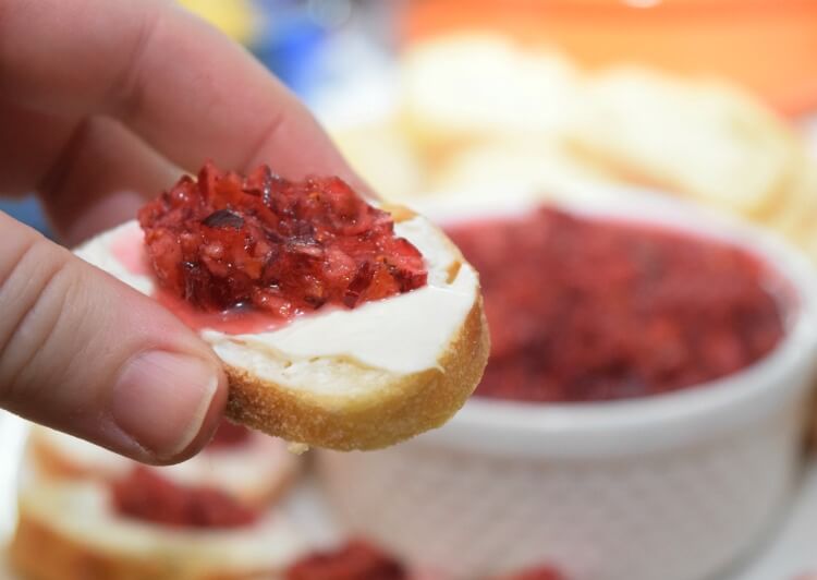 Cranberry Orange Relish on a slice of baguette topped with cream cheese.