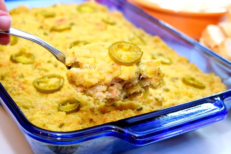 A spoonful of the jalapeno spicy cornbread dressing over the casserole dish.