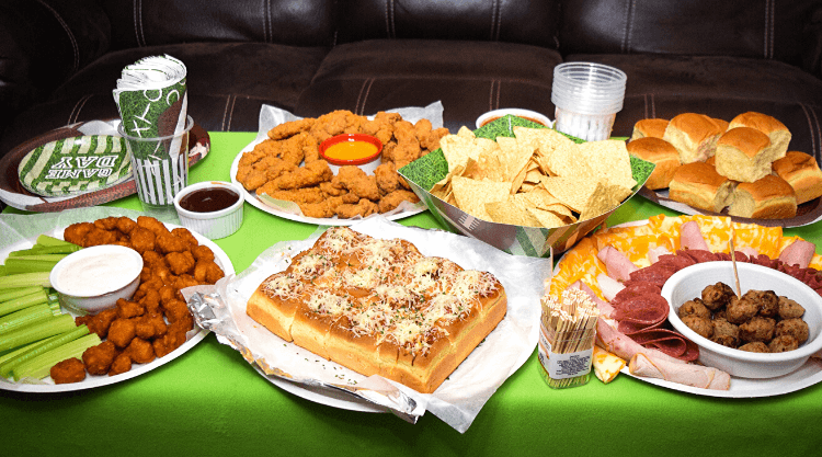 The table full of game day favorites including Tyson products and Chicken Meatball Sliders.
