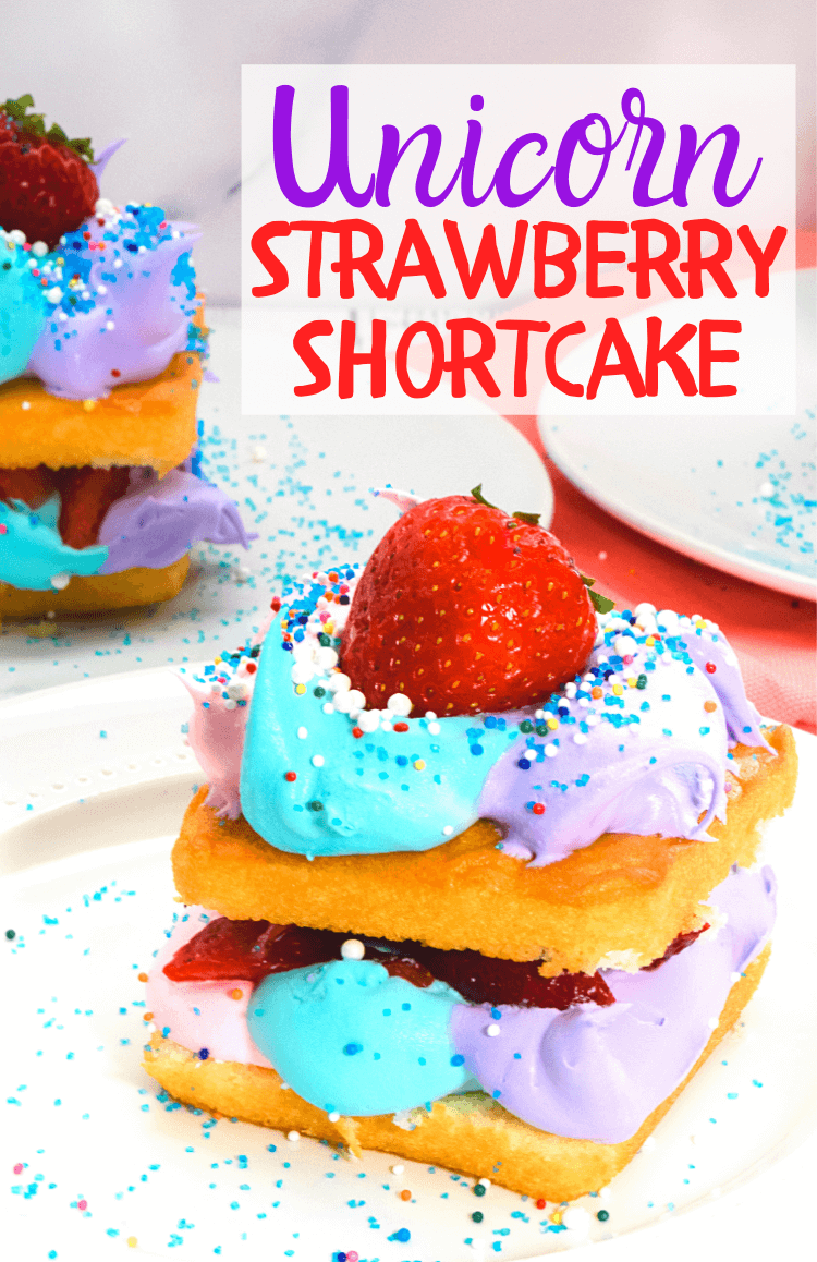 Unicorn strawberry shortcake with pink, purple, and blue whipped cream. 