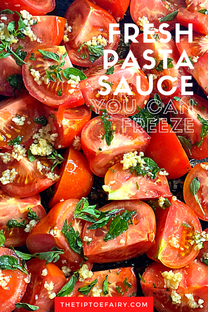 A close up of raw tomatoes quarters covering in mined garlic and herbs. 