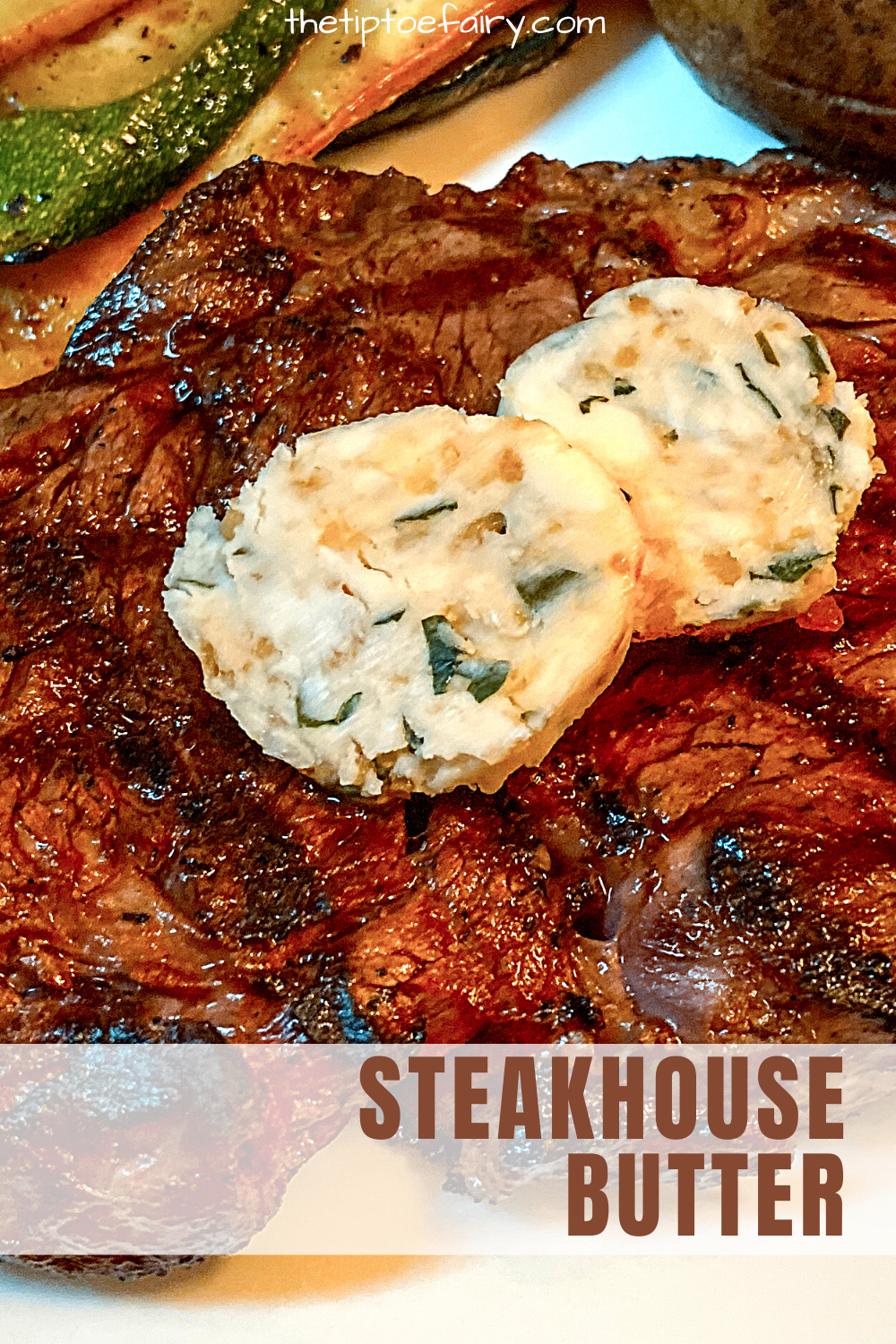 Close up view of a grilled ribeye steak with two slices of steakhouse butter on top of it. 