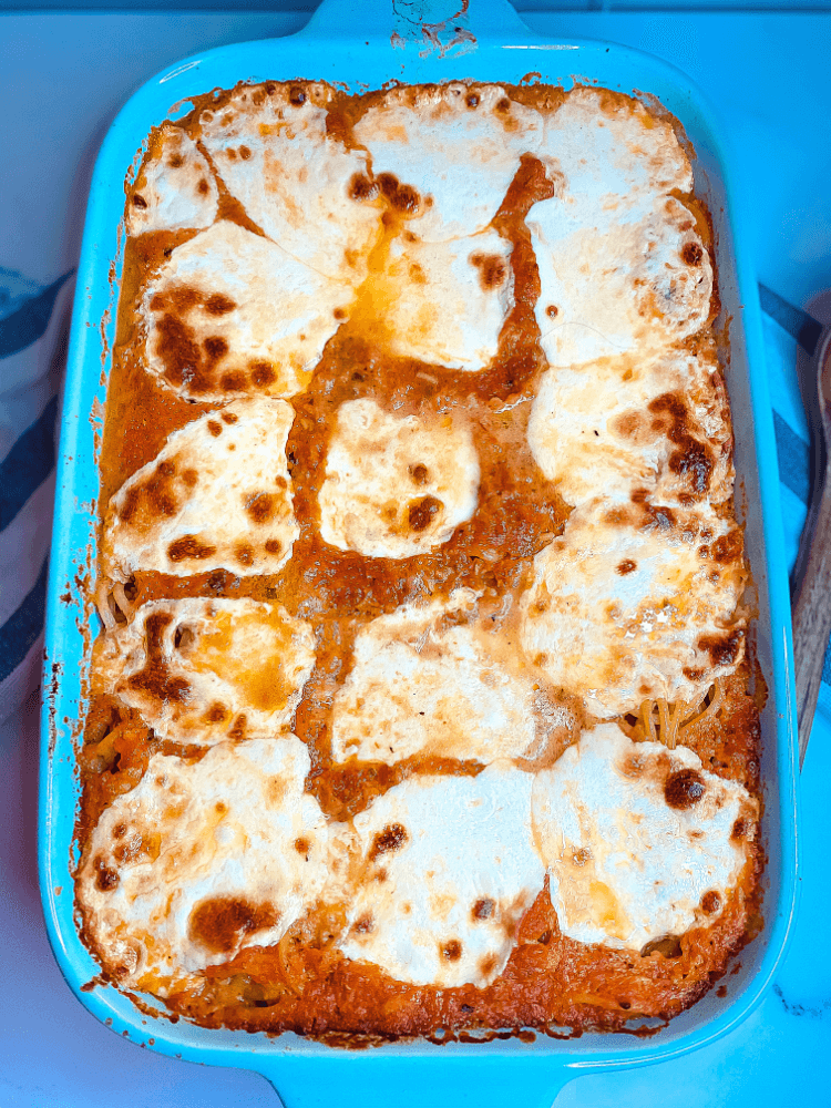 Overhead shot of spaghetti casserole with melted cheese. 