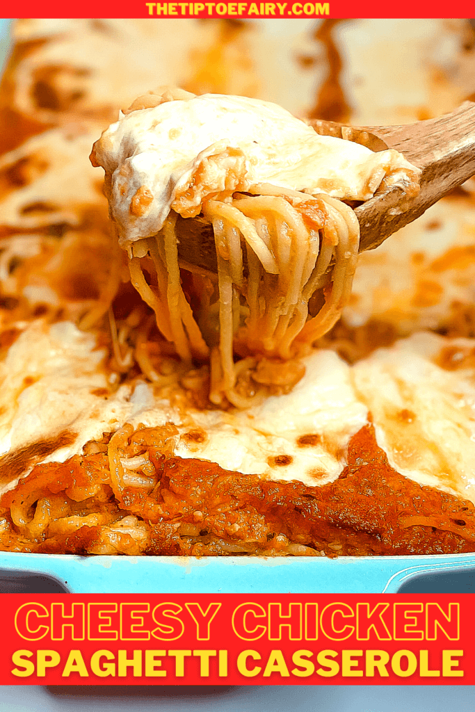 Spaghetti casserole with a spoonful of spaghetti being lifted over the casserole. 