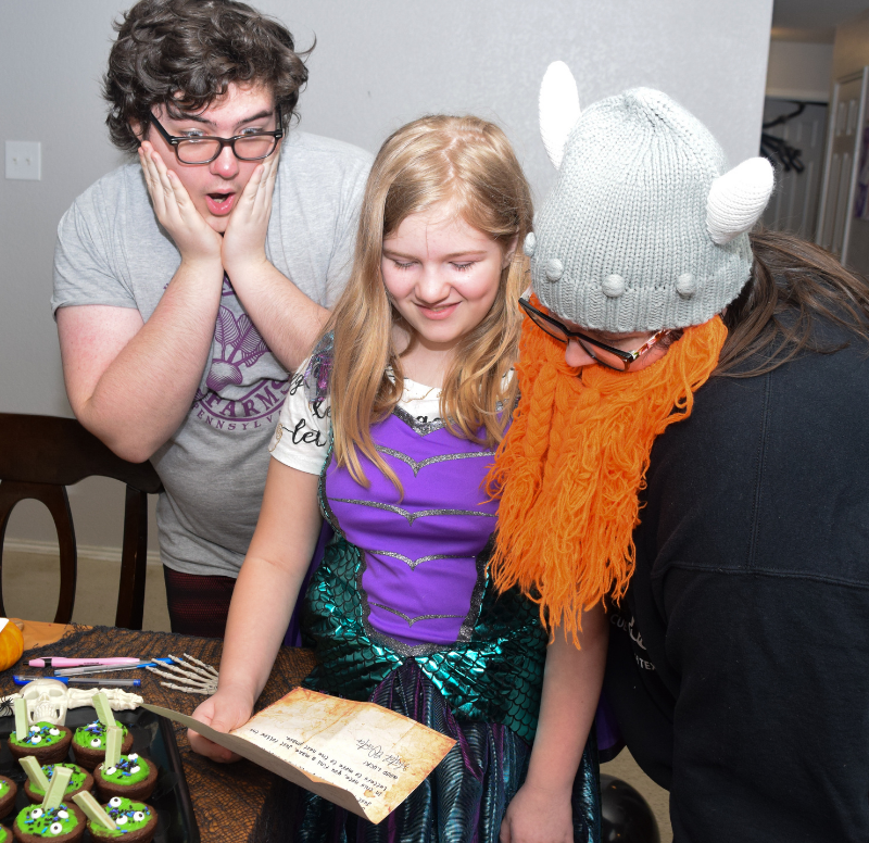 Teens and tweens reading over the starting letter for the Halloween escape room at home. 