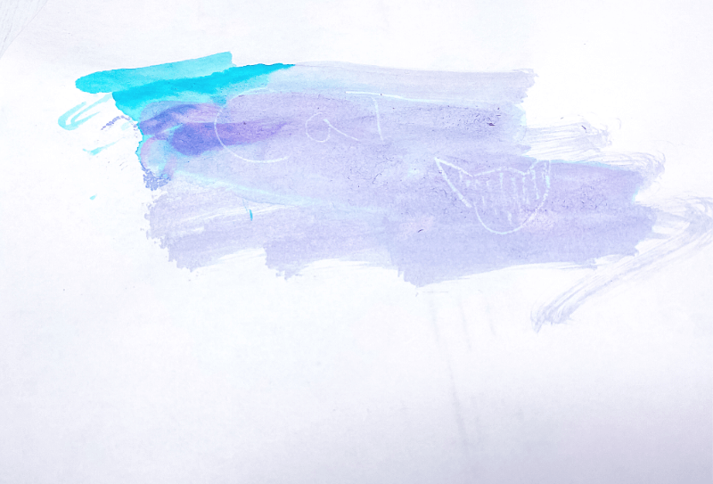 The invisible message made by white crayon is revealed with water colors