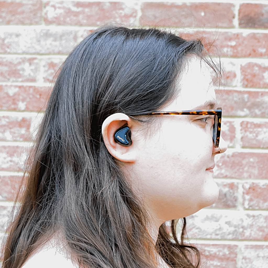 Young woman wearing PaMu Nano earbuds