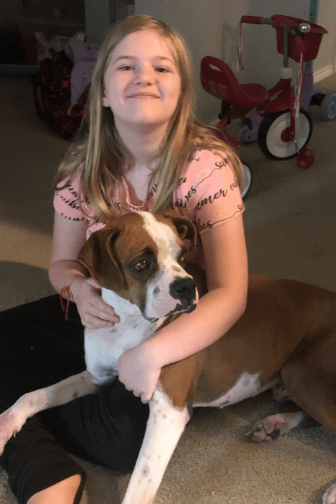 11 year old girl and her Boxer dog