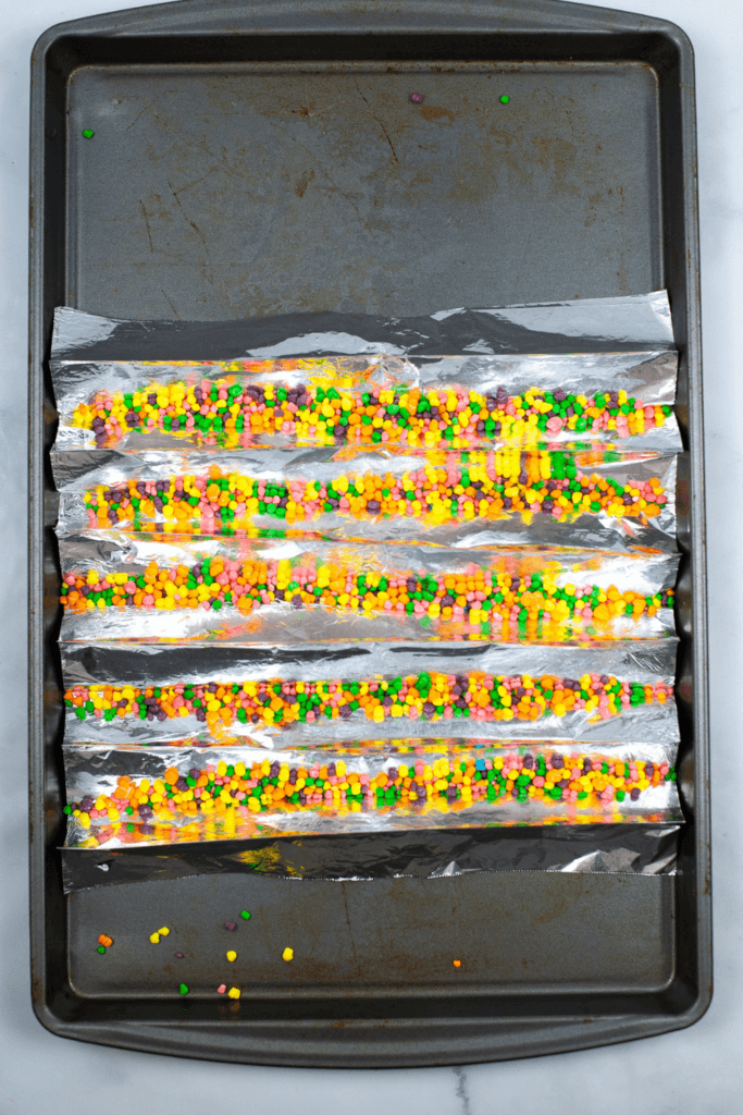 Cookie sheet with foil troughs filled with Nerds Candy