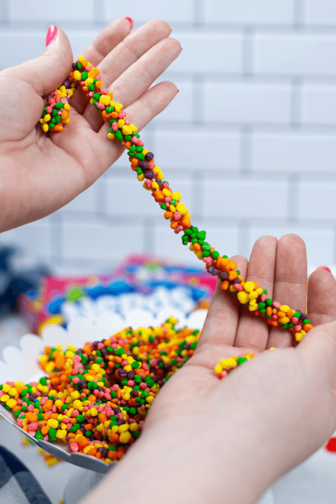 A foot-long Nerds Rope held up in hands. 
