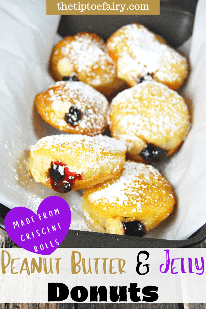 Six peanut butter and jelly donuts layered in a loaf pan topped with powdered sugar. 