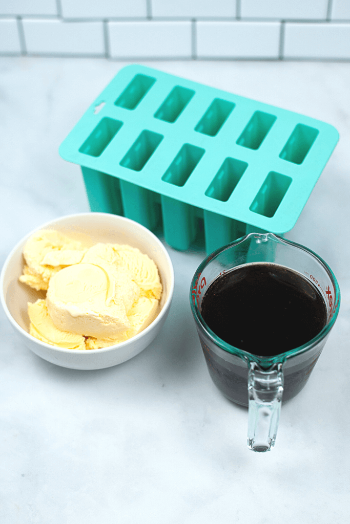 Ingredients and popsicle mold to make Root Beer Float Popsicles with just 2 ingredients