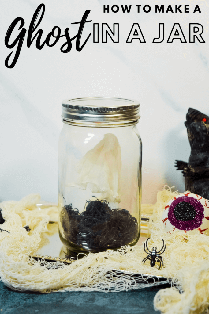 Ghost in a jar with a plastic rat next to it