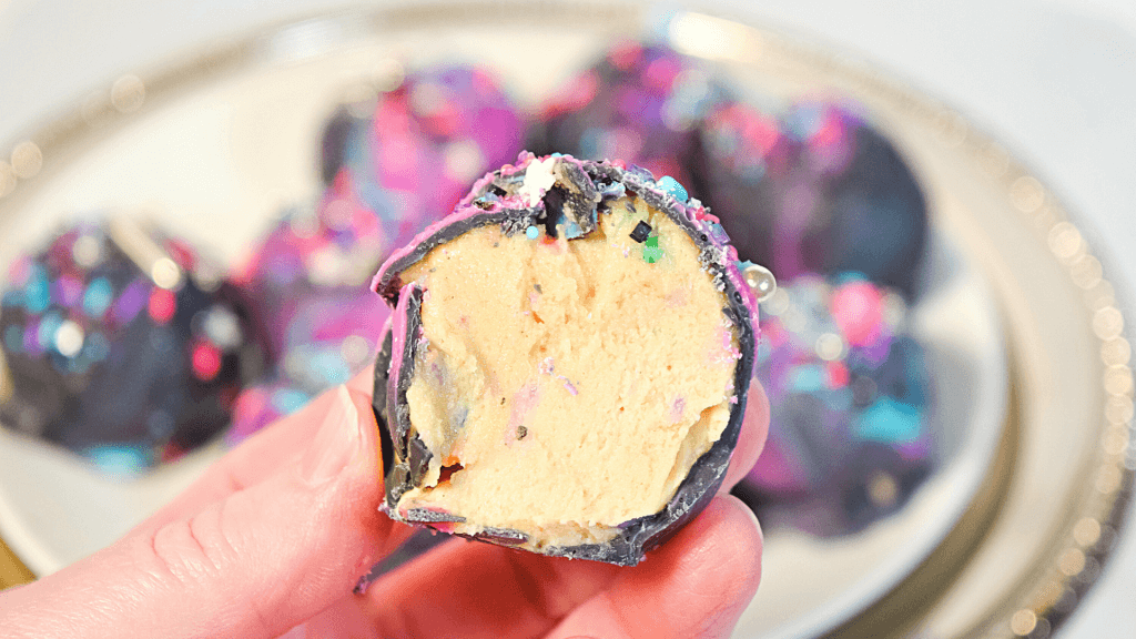 A moon rock cookie dough bite cut in half to show the inside. 