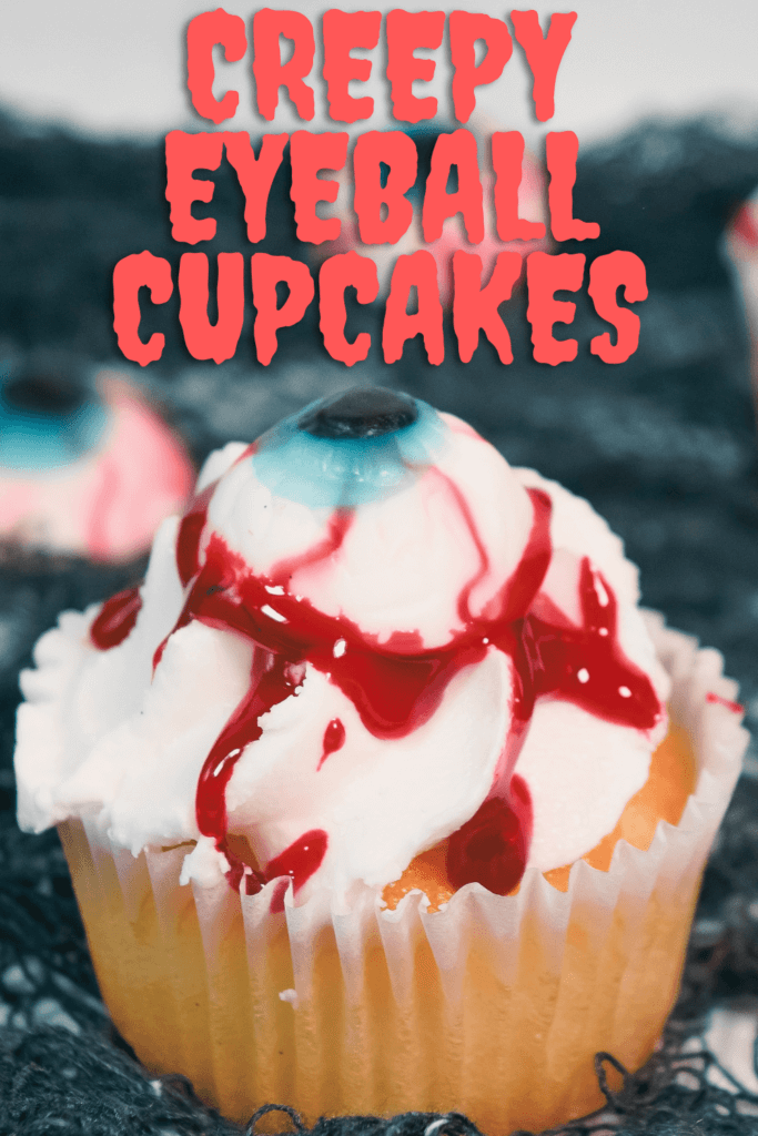Creepy Eyeball Cupcakes made from store bought cupcakes with a gummy eyeball and blood glaze dripping down the white frosting