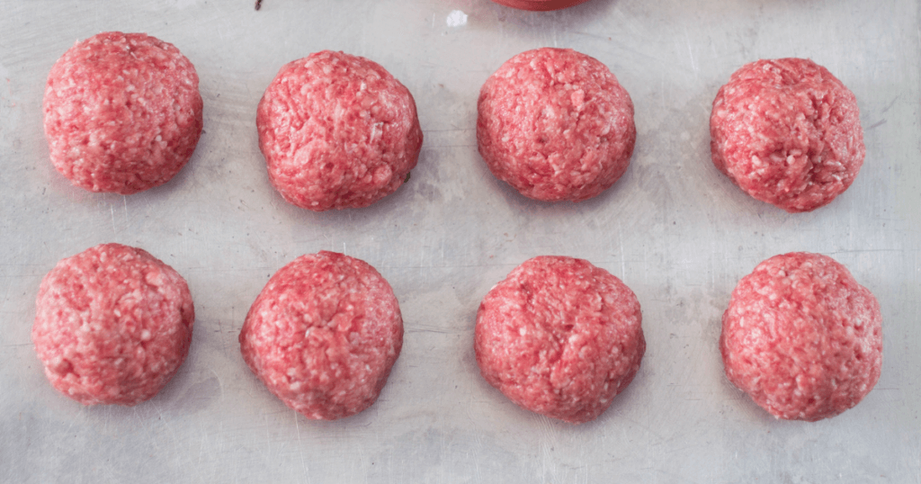 Raw meatballs on parchment paper