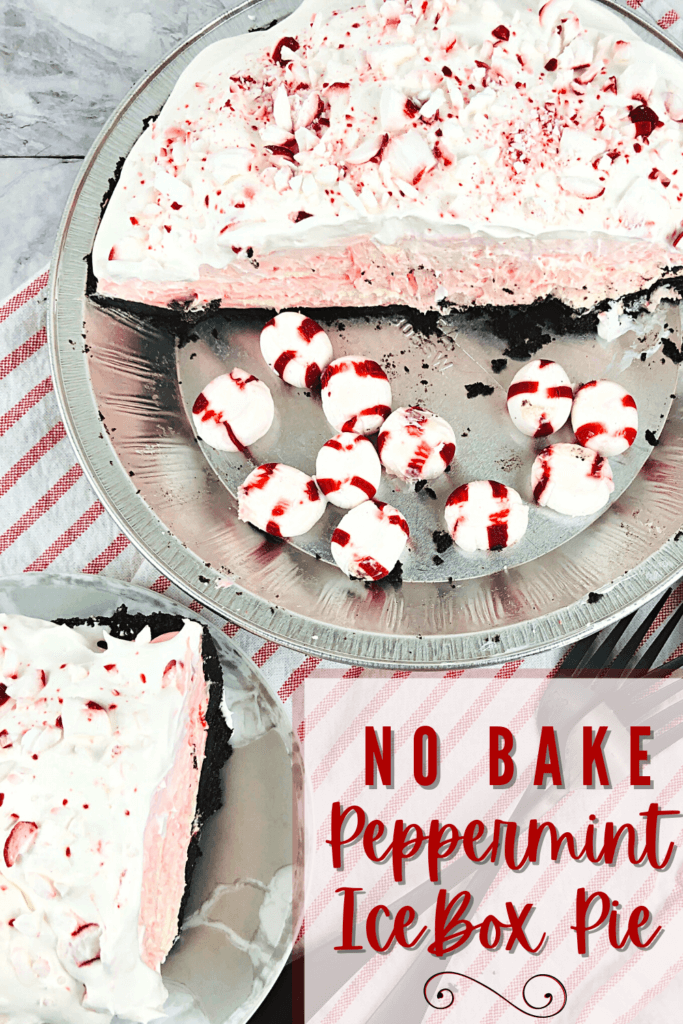 Half a no bake peppermint icebox pie in a pie plate with peppermint candies in the other half with a slice of peppermint pie on a silver plate all on a red striped background.