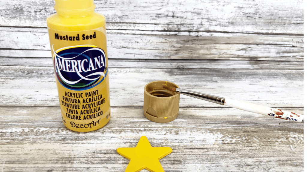 Painting the wooden star bright yellow