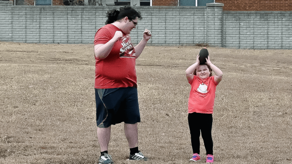 Teen and little girl celebrating catching a football!