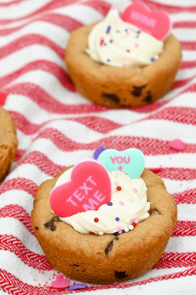 Valentine Cookie Cup on a red striped towel with sprinkles around.