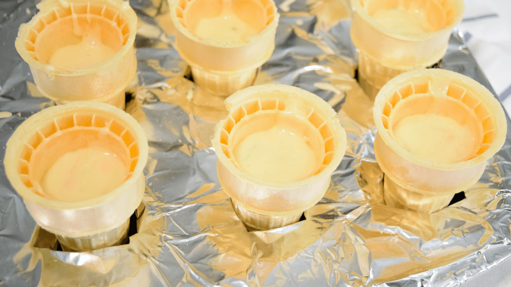 Ice cream cones filled with cake batter. 