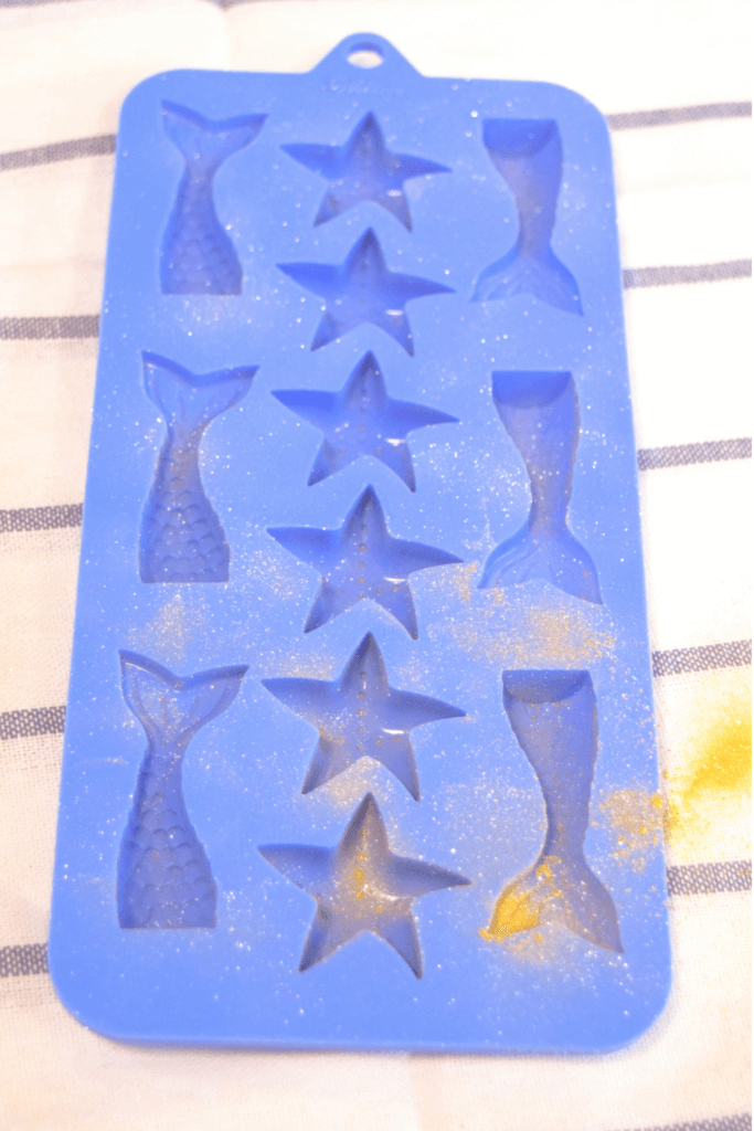 The blue mermaid tail mold sprayed with gold glitter spray. 