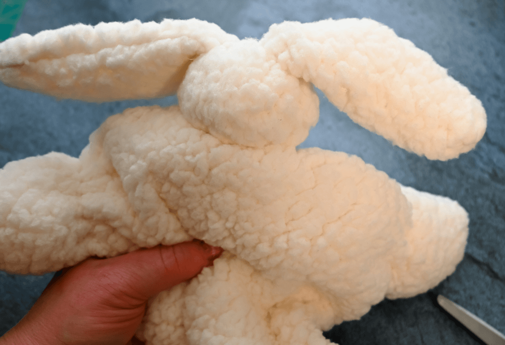 Insert the head into the body of the snuggle bunny. 